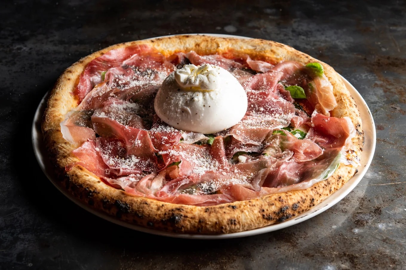 The pizzas here are baked in a wood-fired oven